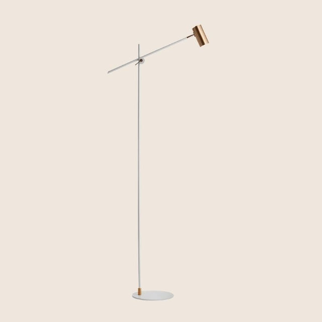 "Contemporary steel floor lamp with a white finish and adjustable arm"