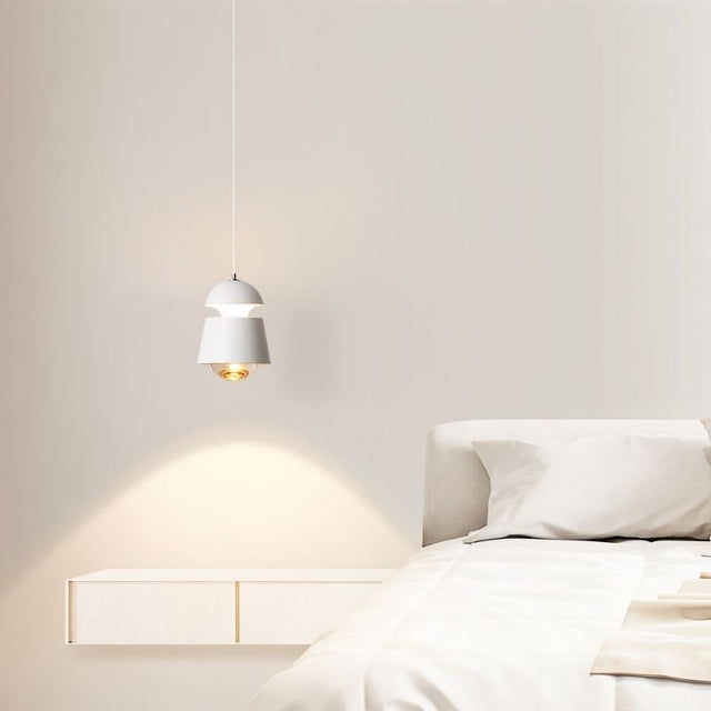 "Sleek pendant light with a layered metal and glass design, providing soft lighting for a stylish bedroom."