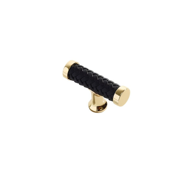"Black braided leather knob with gold accents, isolated on a white background."