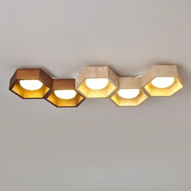 "Front-on view of honeycomb ceiling lamp with hexagonal design, travertine and walnut details"