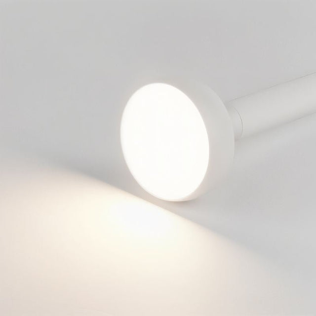 "Close-up of white cylindrical ceiling light with bright illumination, minimalist design, and aluminum material."