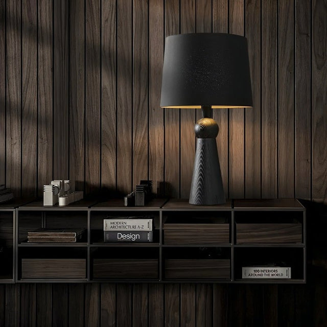 "Minimalist table lamp with wooden base and fabric shade, placed in a modern room, crafted from high-quality wood and fabric for longevity."