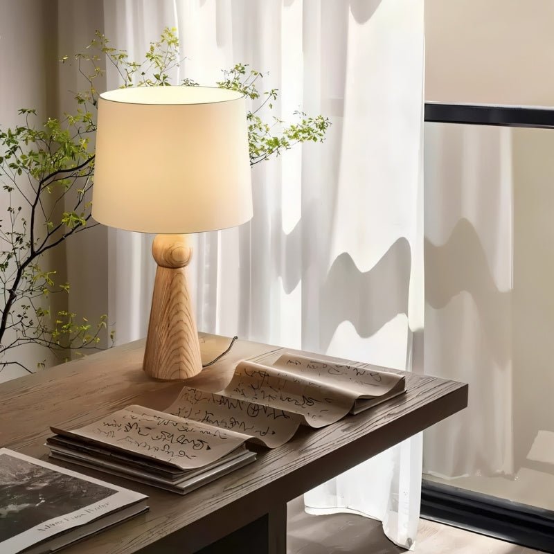"Elegant table lamp with wooden base and fabric shade, providing soft, warm light for a cozy atmosphere, crafted from premium wood and fabric."