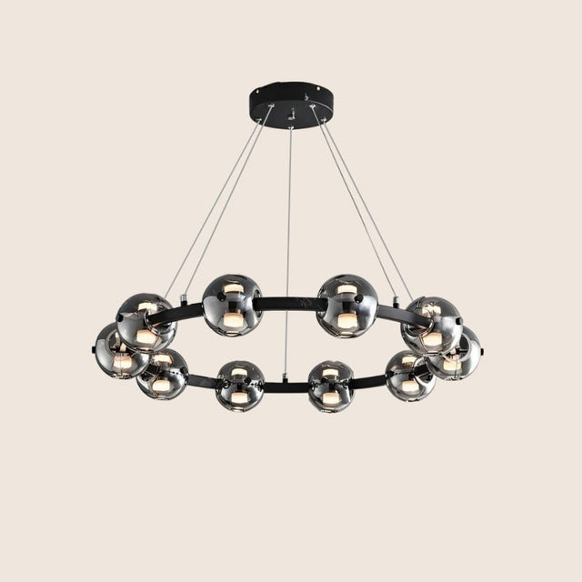 "Modern chandelier with aluminum frame and smoked glass orbs, suspended from the ceiling."