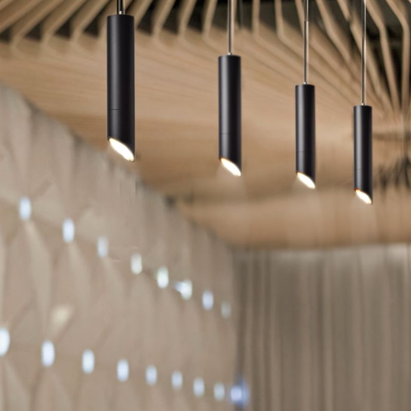 "Cluster of black pendant lights, modern aluminum design, minimalist lighting, enhancing ambient room décor"