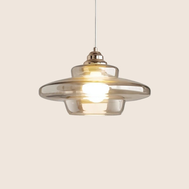 "Thuli pendant light with a metallic accent and a clear glass shade, ideal for dining or living areas."