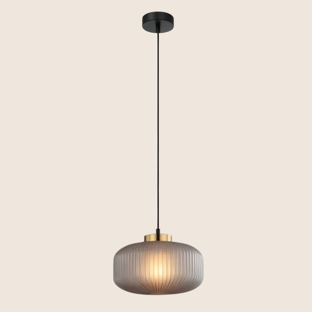 "Pendant light with soft gray glass shade and elegant gold finish, providing a modern and sophisticated touch."