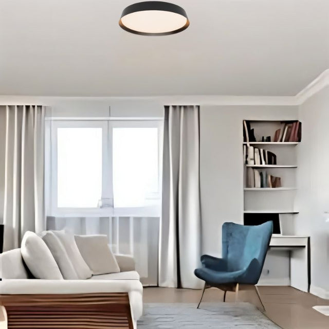 Zena Ceiling Lamp in black mounted in a cozy living room, blending minimalist design with functional ambient lighting for contemporary interiors.