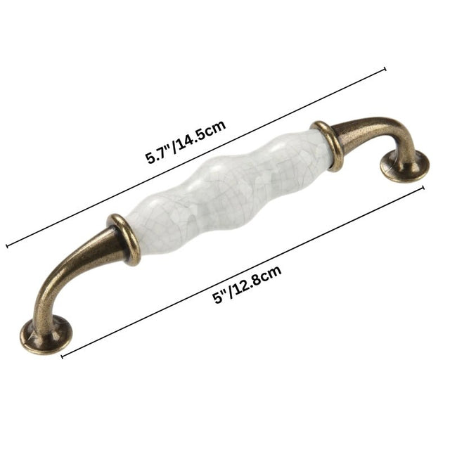 "Dimensions of a ceramic pull bar handle with a crackled glaze and antique brass supports, shown with measurements in inches and centimeters."