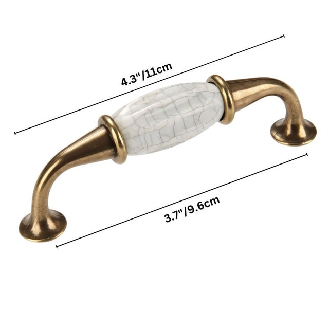 "Dimensions of a ceramic pull bar handle with a crackled glaze and antique brass supports, shown with measurements in inches and centimeters."