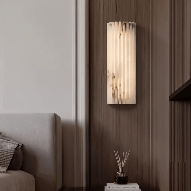 "Modern cloud stone wall lamp with a vertically grooved design, mounted on a wall in a contemporary home setting."