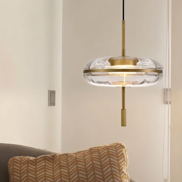 "Close-up of a sculptural glass pendant light with rippled texture and metal frame."