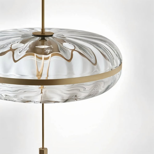 "Close-up of the textured glass on a sculptural pendant light with metal frame."
