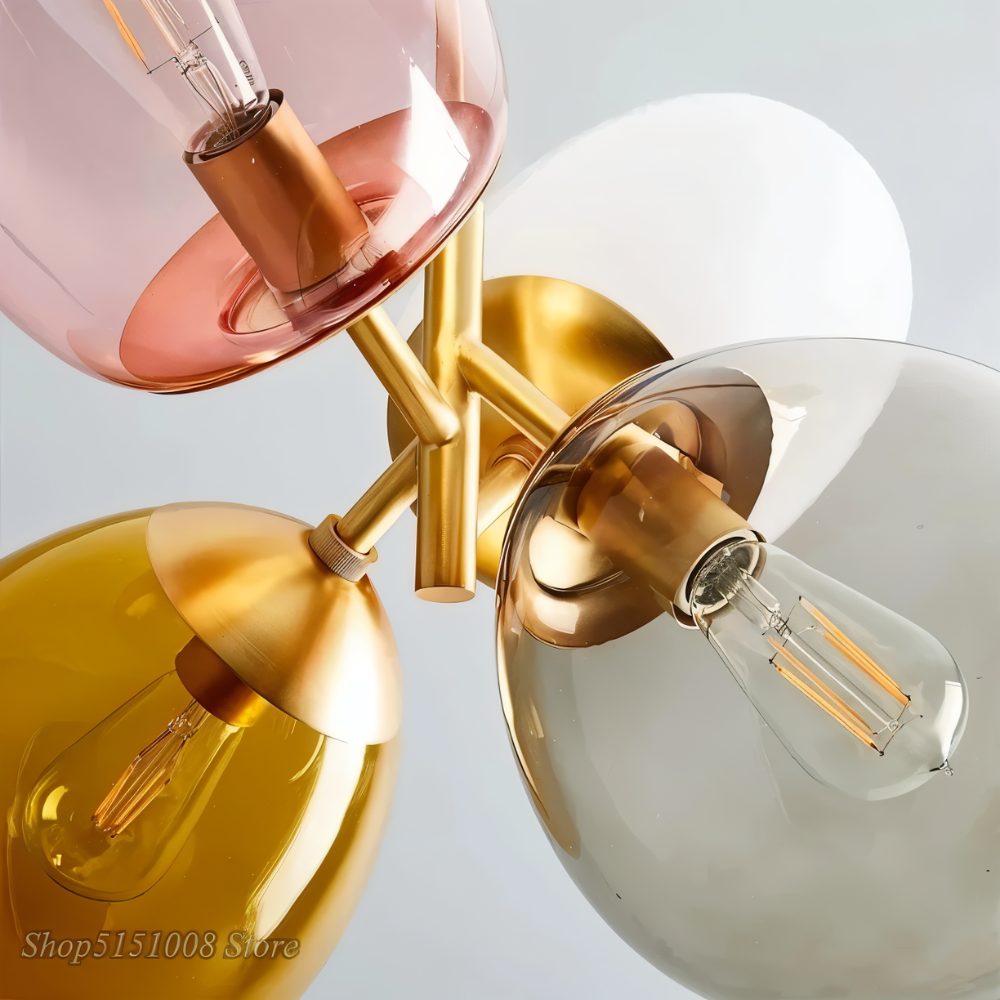 "Close-up detail of a pendant light with clustered asymmetrical glass shades and exposed bulbs."