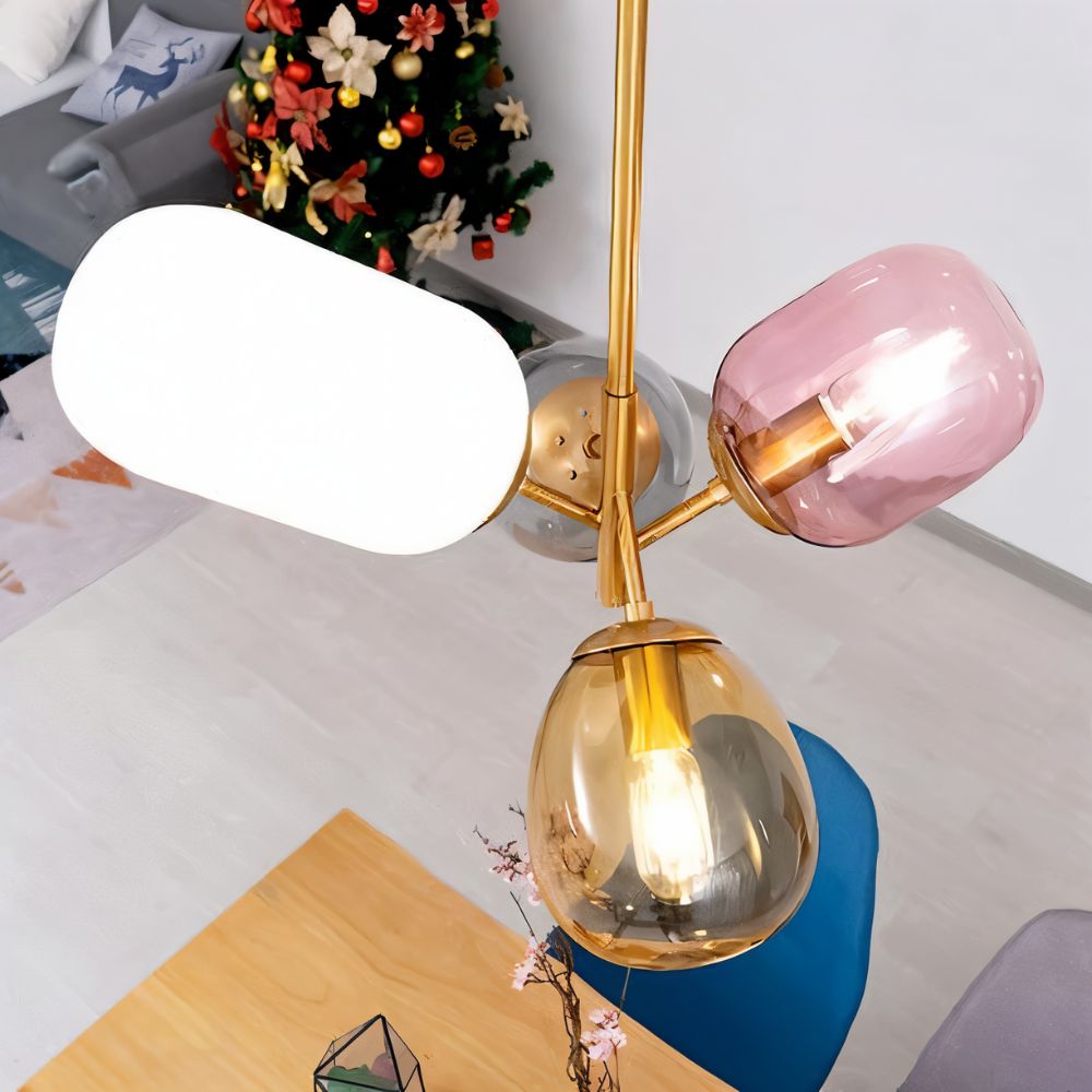 "Close-up detail of a pendant light with clustered asymmetrical glass shades in warm tones."