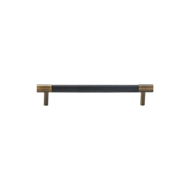 "A modern black leather and brass cabinet pull bar on a white background."