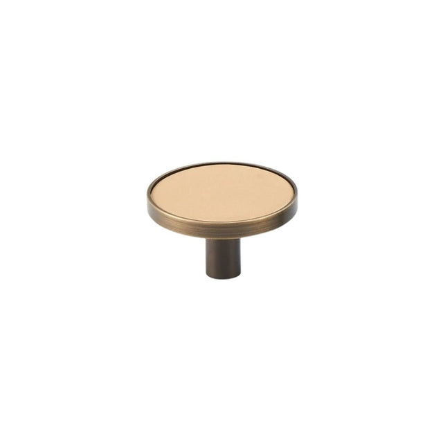 "Angled view of a tan leather and brass knob with stitching detail, isolated on a white background."