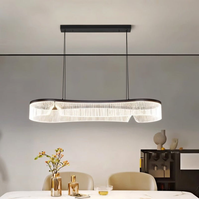 "Modern chandelier with a sleek iron frame and undulating acrylic shade illuminating a contemporary dining room."