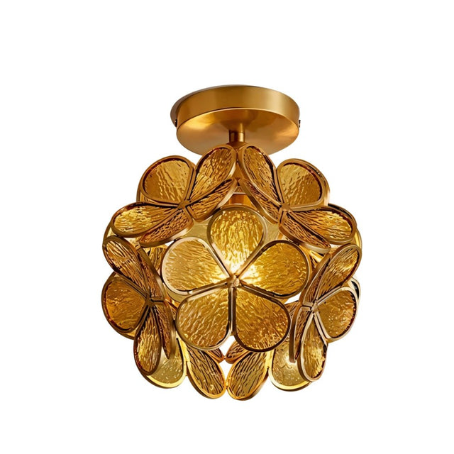 "An amber floral ceiling light with a brass frame and textured glass petals, radiating a warm and inviting glow."