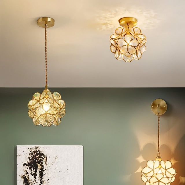 "A collection of floral-inspired ceiling lights with brass frames and delicate glass petals, showcasing various styles and arrangements in a room."
