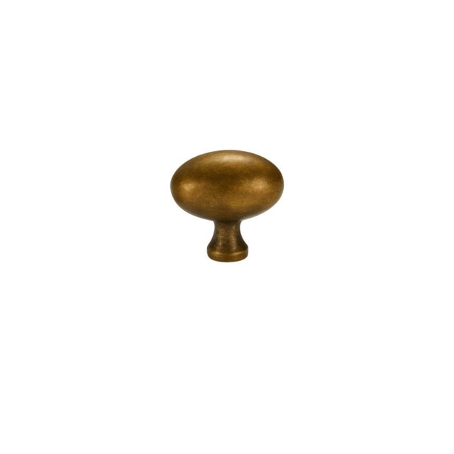 "An oval antique brass knob with a smooth, ergonomic grip, suitable for cabinets, drawers, and doors."