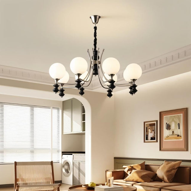 "Modern chandelier with curved arms and frosted glass globes in a contemporary living room."