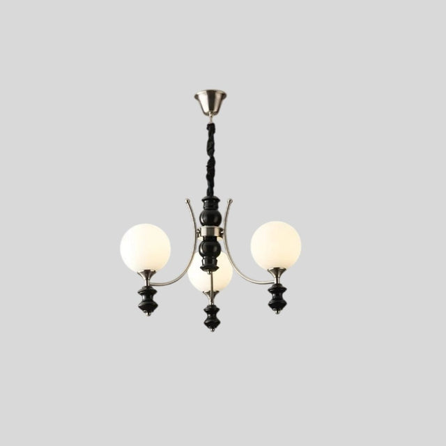 "Modern chandelier with three frosted glass globes, curved arms, and black detailing, isolated on a white background."