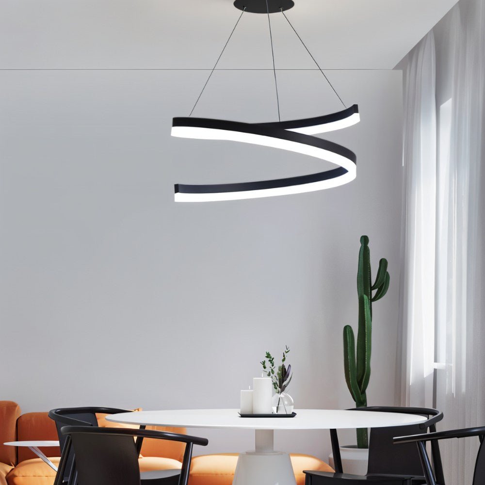"Modern pendant light with a black spiral ribbon design over a round dining table."