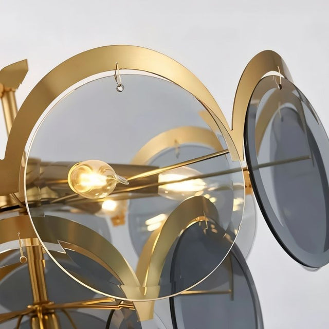 "Close-up of a modern chandelier with layered smoked glass discs, showing a light bulb illuminating the translucent material."