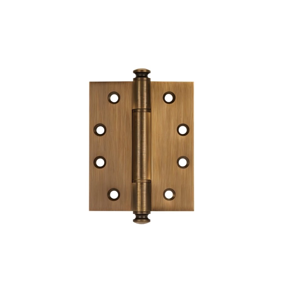 "An antique brass solid barrel hinge with decorative finials, isolated on a white background."