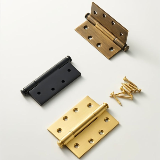 "Three solid brass barrel hinges with decorative finials in various finishes (antique, black, and polished), shown with screws on a light background."