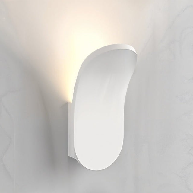 "Close-up of a modern wall lamp made from gypsum and aluminum, showcasing an elegant organic design that casts soft upward light, ideal for contemporary interior spaces."