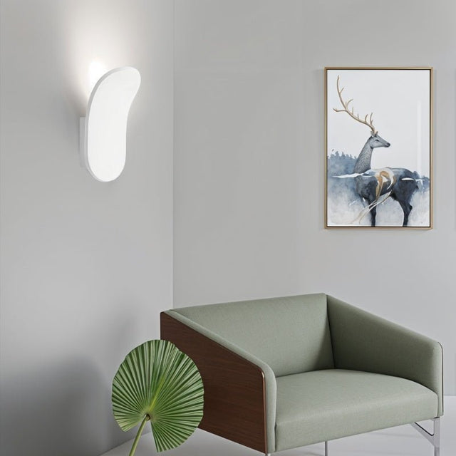 "Contemporary wall lamp made from gypsum and aluminum, featuring an organic design that directs soft light upward, perfect for modern interiors like hallways, living rooms, or bedrooms."