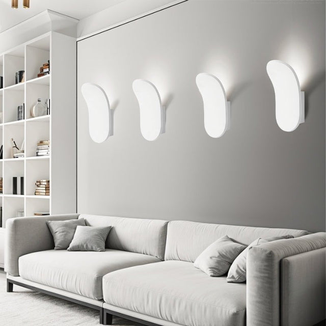 "Set of modern wall lamps made from gypsum and aluminum, showcasing an elegant organic design that casts soft light upward, enhancing contemporary living rooms or lounges."