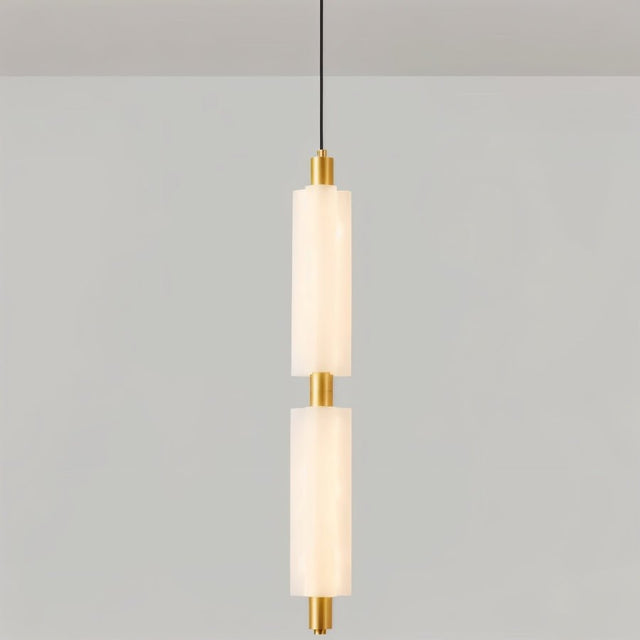 "A double-tiered, minimalist pendant light with two frosted acrylic cylinders and brass accents, hanging from a thin black cord."