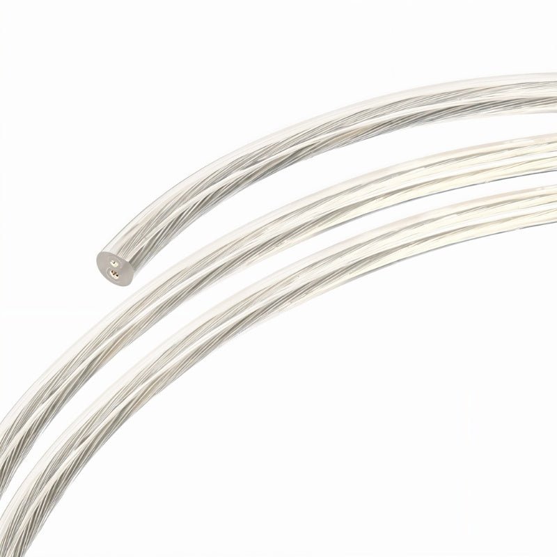 Silver braided cable coiled in curves against white background.