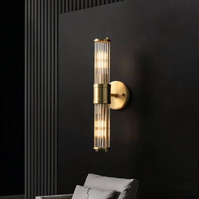 "A modern wall lamp with clear glass panels mounted on a black wall, providing a sophisticated and elegant glow."