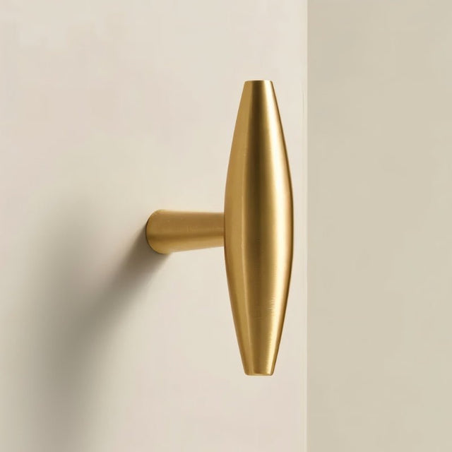"Modern brass T-bar cabinet knob with a sleek, minimalist design."