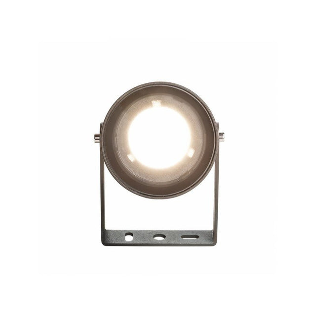"Front view of a lit black outdoor spotlight with a round lens, showing the light emitted, on a white background."