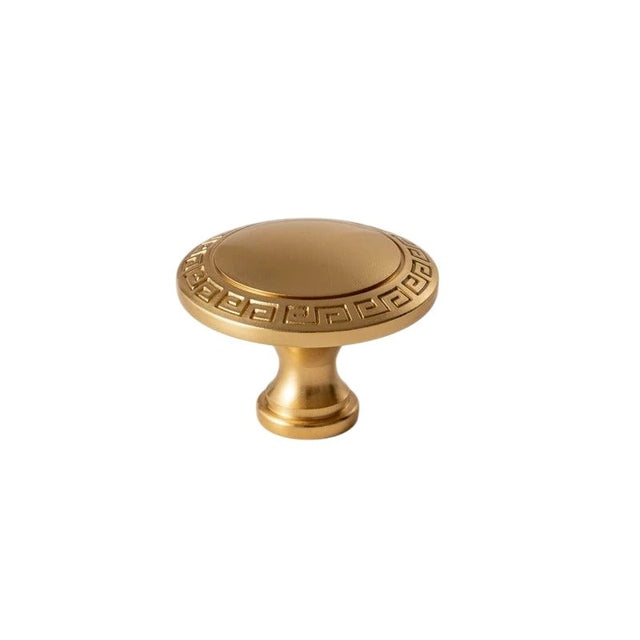 "Vintage solid brass knob with intricate Grecian-inspired patterns, enhancing the elegance of classic cabinetry."
