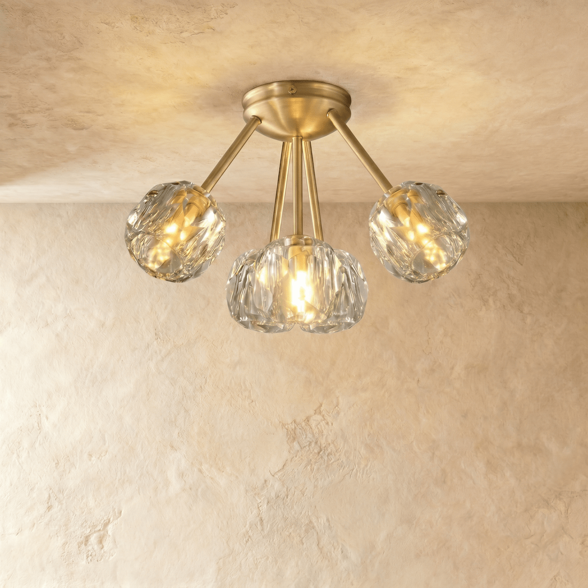 Gold flush mount ceiling light with seven textured crystal glass shades, lifestyle setting with white walls and gray curtains