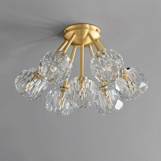 "Modern flush mount ceiling light with crystal shades and brass finish."