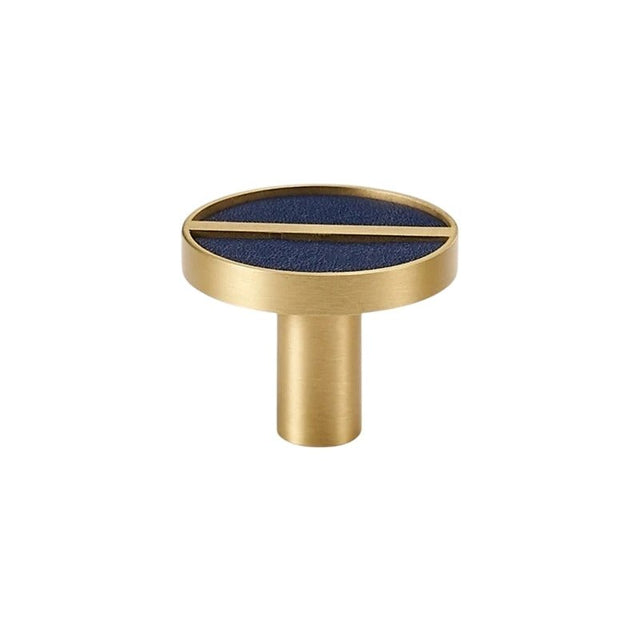 "Circular brass knob with a blue leather inlay and central bar, isolated on a white background."