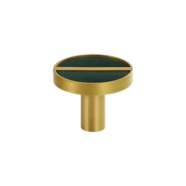 "Circular brass knob with a green leather inlay and a central bar."