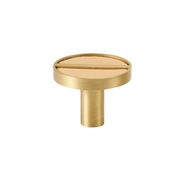"Circular brass knob with a tan leather inlay and central bar, isolated on a white background."
