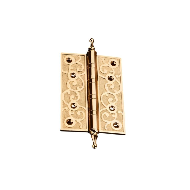 "Single brass door hinge with ornate scrollwork design, isolated on a white background."
