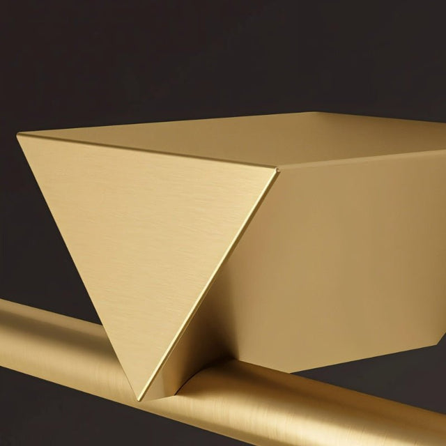 "A close-up view of the Dalane LED wall lamp, showcasing its geometric accent and gold finish."