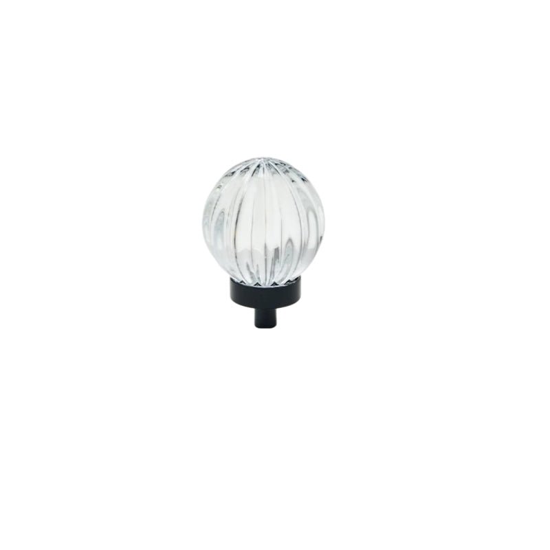 "Clear crystal glass spherical knob with ribbed texture and black base, isolated on a white background."