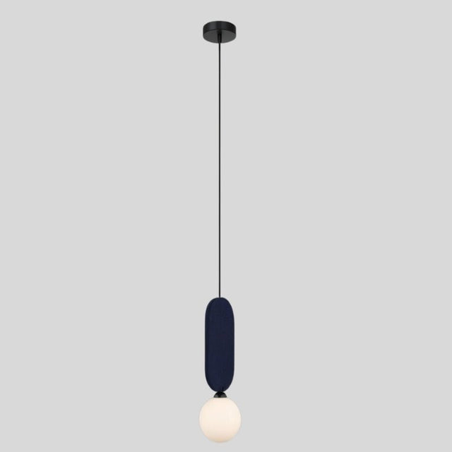 "The Dorea Pendant Lamp with a navy blue fabric panel and spherical glass bulb adds a minimalist, modern touch to any room with soft ambient lighting."