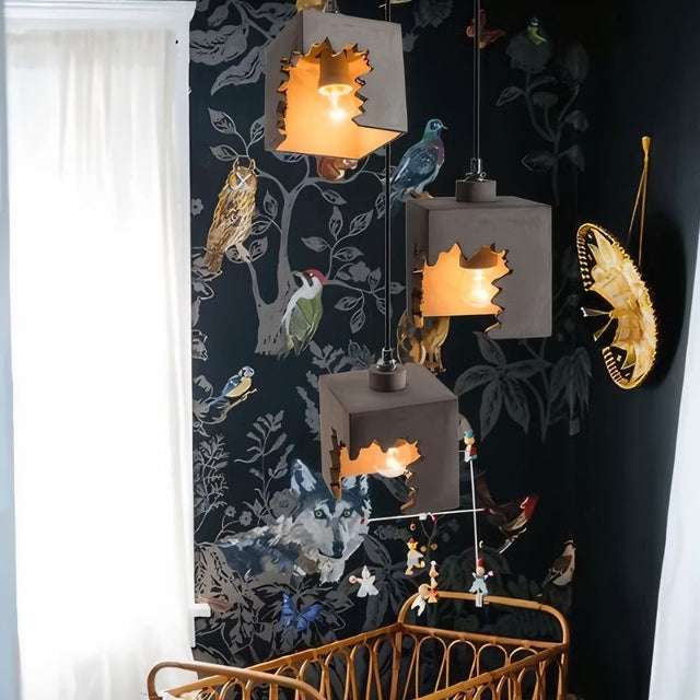 "Concrete pendant lights with jagged cutout design hanging in a nursery, casting warm ambient lighting"